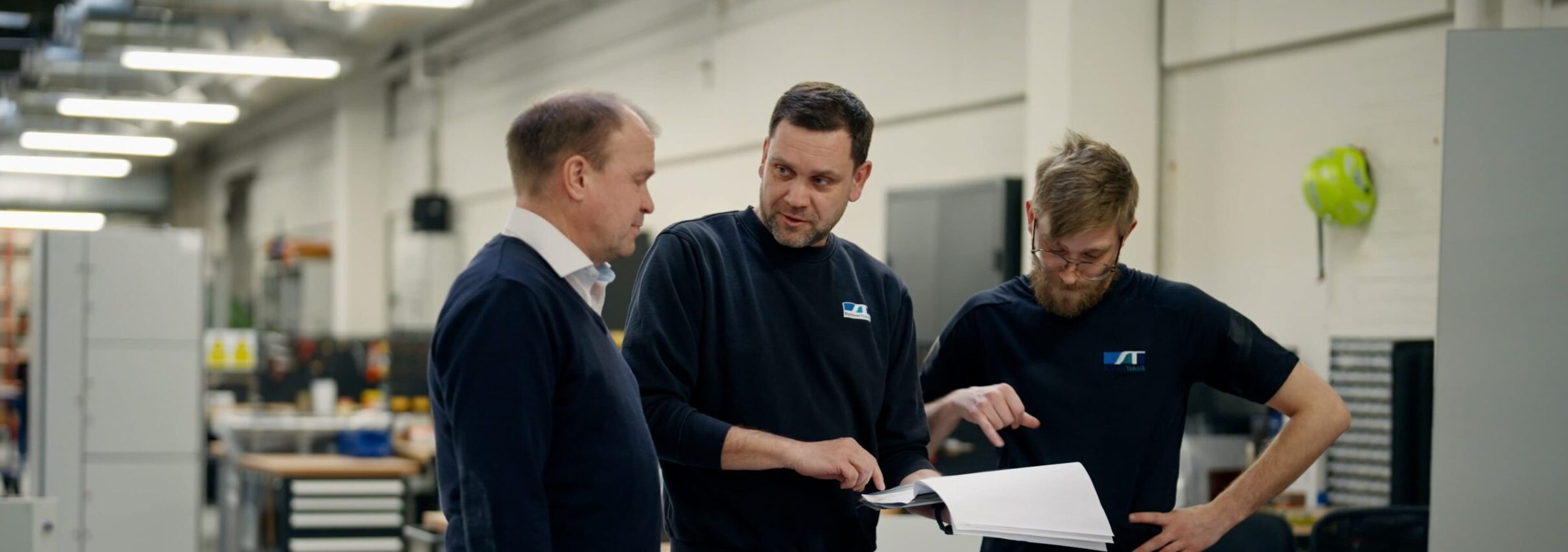 Employees reviewing drawings in production