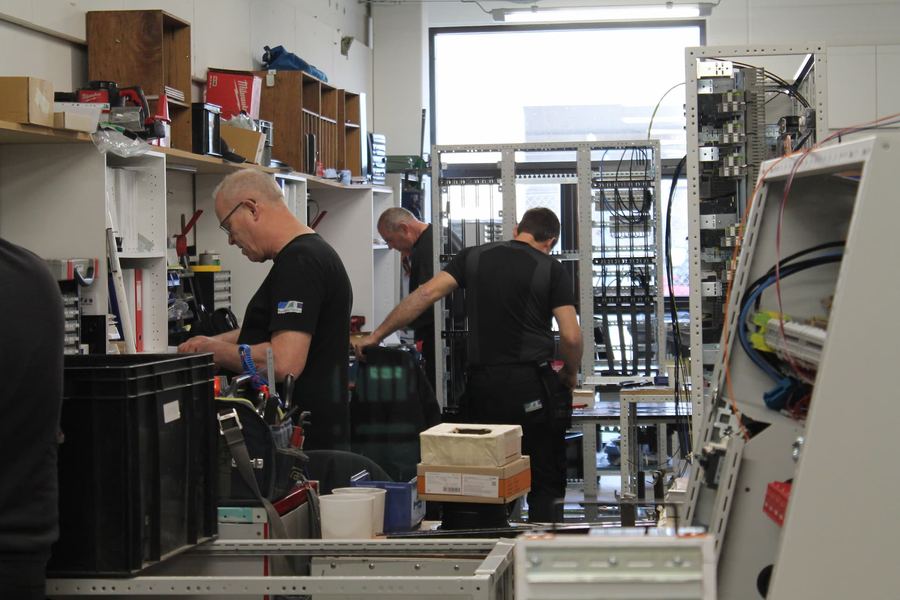 Employees assembling panels in production