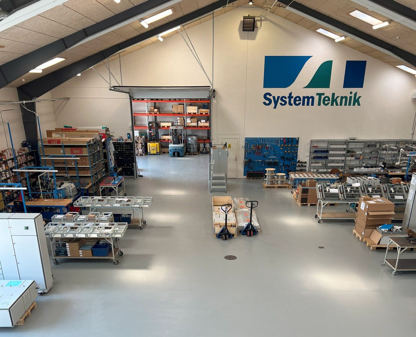 SystemTeknik's production hall with workbenches and panel enclosures